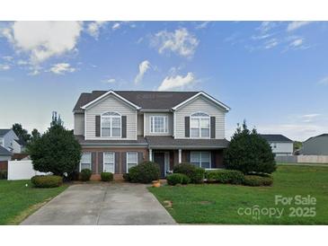 Charming two-story home with landscaped yard and welcoming entrance at 125 Mallory Tai Dr, Lincolnton, NC 28092