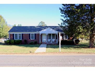 Brick ranch home with a well-maintained lawn and walkway at 150 Wilson St, Chester, SC 29706