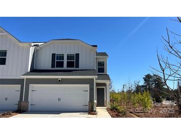 Charming two-story home with a two-car garage and modern architectural details at 1602 Village Grove Ln, Monroe, NC 28110