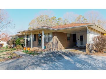 Charming single-story brick home featuring a covered front porch and a convenient carport at 907 Vista Dr, Cherryville, NC 28021