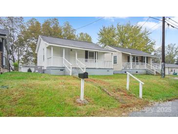 Charming home featuring a quaint front porch and well-maintained lawn at 408 E Washington Ave, Bessemer City, NC 28016