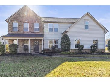 Two-story house with brick and siding exterior, landscaped lawn, and a welcoming front porch at 107 Ashton Dr, Mooresville, NC 28115