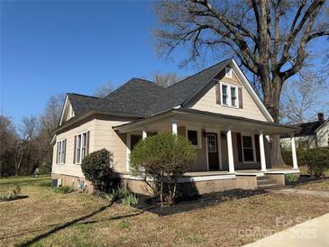 Charming home featuring a covered front porch with white columns and a well-maintained yard at 126 E Division Ave, Salisbury, NC 28144