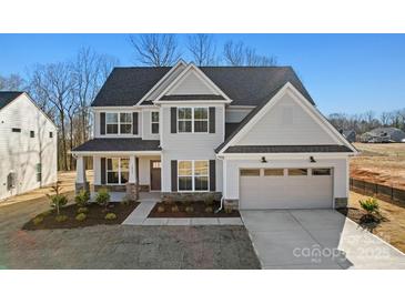 Charming two-story home with a welcoming entrance, landscaped yard, and attached two-car garage at 1065 Kinship Dr # 080, Lancaster, SC 29720