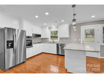 Updated kitchen features stainless steel appliances and granite countertops at 130 Island Park Ln, Statesville, NC 28625