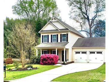 Charming two-story home featuring a well-manicured lawn and a two car garage, perfect for any Gathering at 13112 Appolinaire Dr, Davidson, NC 28036
