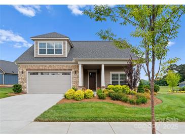Attractive Craftsman style home with stone accents and landscaped front yard at 15126 Sustar Farm Dr # 36, Matthews, NC 28105