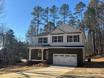 Two-story home with brick and white siding, a large garage, and a front porch at 403 Imperial Way # 24, Albemarle, NC 28001