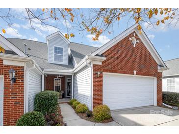 Charming brick and vinyl home featuring an attached garage and well-manicured landscaping at 284 Garnet Ct, Fort Mill, SC 29708
