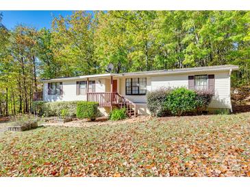 Charming home with a yard covered in leaves and surrounded by lush green trees at 5320 Liberty Hill W Rd, York, SC 29745