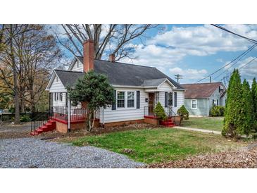 Charming white house with red steps, brick chimney, and landscaping at 1235 10Th Ne St, Hickory, NC 28601