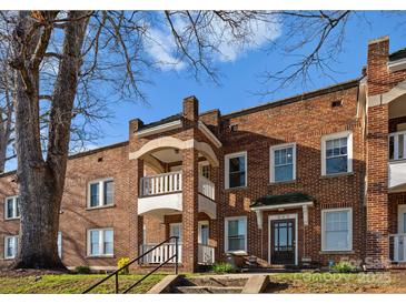 Charming brick apartment building with a quaint balcony and inviting entrance under a partly sunny sky at 843 Ideal Way # 11, Charlotte, NC 28203