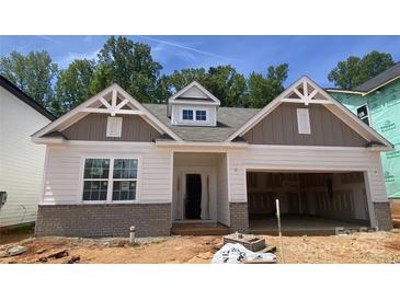New construction with brick accents, covered front porch and two-car garage at 9130 Dulwich Dr # Ken0079, Charlotte, NC 28215