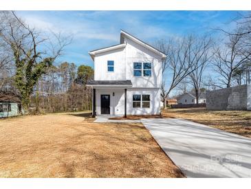 Charming two-story home with vertical siding and a concrete driveway at 1097 Georgetown Rd, Lincolnton, NC 28092