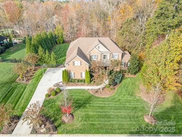 Brick house with a large green lawn and driveway, seen from above at 3014 Highbury Pl, Weddington, NC 28104