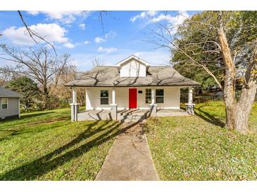 Charming home featuring a vibrant red front door and a welcoming covered porch at 612 E E St, Newton, NC 28658