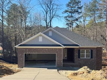 Brick home with gray siding, two-car garage, and a landscaped yard at 401 Imperial Way # 25, Albemarle, NC 28001