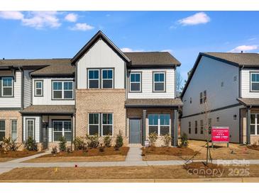 Two-story home with gray and white exterior, landscaping, and walkway at 1194 Lost Cove Rd, Indian Land, SC 29707