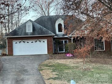 Brick ranch home with attached garage and driveway at 1801 Brandywine Dr, Matthews, NC 28105