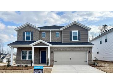 Two-story home with mixed brick and siding, a two-car garage, and a covered front porch at 148 Shepherds Landing Dr, Mooresville, NC 28115