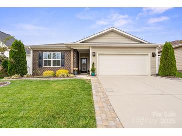 Brick and siding ranch home with landscaped lawn and two-car garage at 5003 Looking Glass Trl, Denver, NC 28037