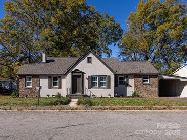 Charming bungalow exterior with stone accents and a well-maintained lawn at 406 Harris Ln, Monroe, NC 28112