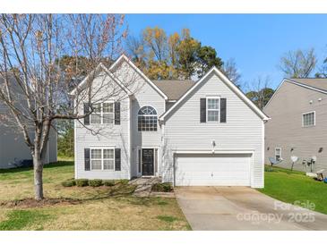 Charming two-story home featuring a well-maintained lawn, attached garage, and classic architectural details at 3015 Hendricks Chapel Ln, Charlotte, NC 28216
