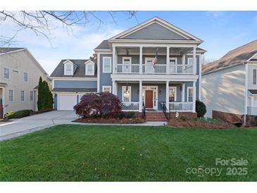 Charming two-story home with inviting double porch and well-manicured lawn at 428 Vintage Hill Ln, Huntersville, NC 28078