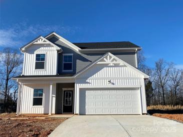 Two-story house with gray and white siding, white garage door, and landscaping at 168 Salem Springs Ln, Statesville, NC 28625