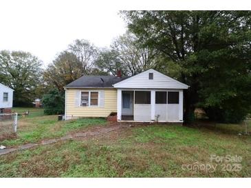 Charming single-story home with a covered porch and well-maintained lawn surrounded by mature trees at 1840 Findlay St, Gastonia, NC 28052