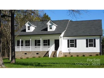 Charming white home with black shutters, dormers, and welcoming front porch on a bright, sunny day at 2270 Charlotte Hwy, York, SC 29745
