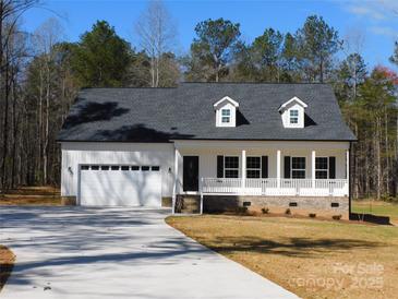 Charming single-story home with white siding, dormer windows, front porch, and an attached two-car garage at 1647 Davis Farm Rd, York, SC 29745