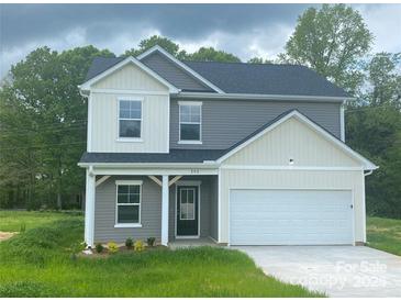 Charming two-story home with a gray and white exterior, showcasing a welcoming front entrance and an attached garage at 282 New Salem Rd, Statesville, NC 28625
