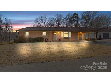 Brick ranch house with attached carport and spacious yard at 2351 Hudspeth Rd, Catawba, NC 28609