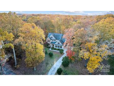 House nestled among autumn trees with a long driveway at 3315 Harvey Ln, Monroe, NC 28110