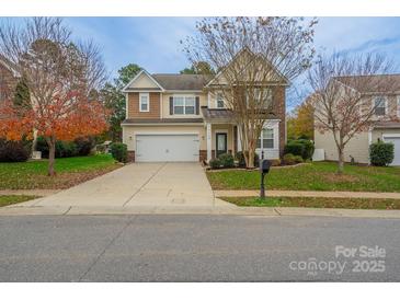 Charming two-story home with a well-maintained front yard and attached two-car garage at 7108 Kinley Commons Ln, Charlotte, NC 28278