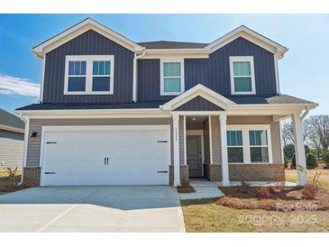 Two story home with a two-car garage, covered entry, and gray and white color palette at 1333 Morehead Dr, Salisbury, NC 28144
