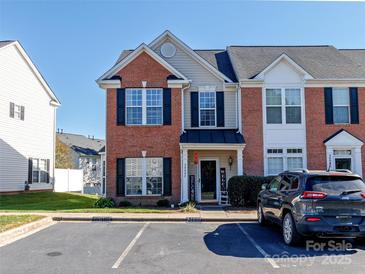 Inviting townhome with brick facade, black shutters, and a welcoming front porch in a well-maintained community at 3000 Misty Harbor Cir # F, Cramerton, NC 28032