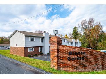 Condominium complex featuring brick and vinyl siding with well-maintained landscaping and signage at 123 23Rd Nw St # E, Hickory, NC 28601