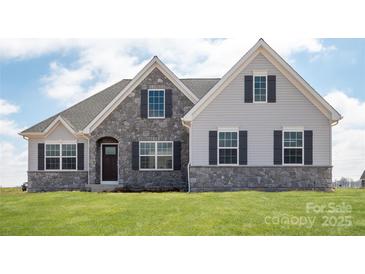 Charming home with a stone facade, gray siding, and a well-manicured lawn at Lot 51 Watercourse Way # Arcadia, Belmont, NC 28012