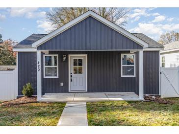 Gray exterior of charming craftsman style home with a covered porch and landscaped yard at 429 Dare Dr, Charlotte, NC 28206