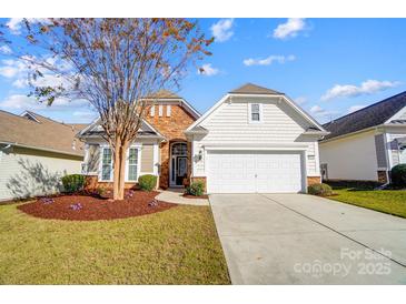 Charming one-story home featuring a well-manicured lawn and a two-car attached garage at 2221 Hartwell Ln, Fort Mill, SC 29707