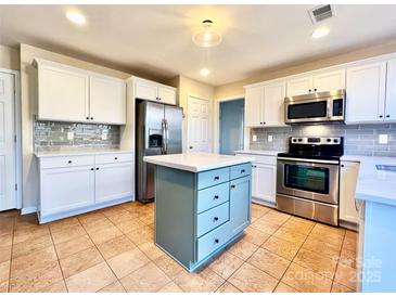 Modern kitchen with stainless steel appliances and an island at 141 Byers Rd, Troutman, NC 28166