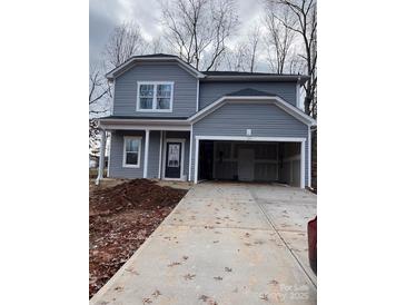 Two-story gray house with attached garage and driveway at 164 Wildwood Loop, Statesville, NC 28677