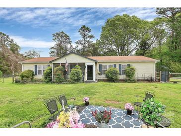 Charming home featuring a lush lawn and a cozy screened-in porch area at 335 Ridgewood Dr, Mt Ulla, NC 28125