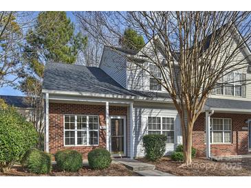 Brick townhouse with a landscaped front yard at 14922 Deshler Ct, Charlotte, NC 28273
