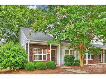 Charming townhouse with brick facade, well-kept landscaping, and mature trees, creating an inviting curb appeal at 14922 Deshler Ct, Charlotte, NC 28273
