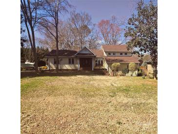 Charming ranch-style home with a welcoming front porch and mature trees on a large lot at 16425 Grapperhall Dr, Huntersville, NC 28078