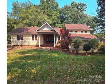 Charming two-story home with a well-maintained front yard and a combination of brick and siding accents at 16425 Grapperhall Dr, Huntersville, NC 28078