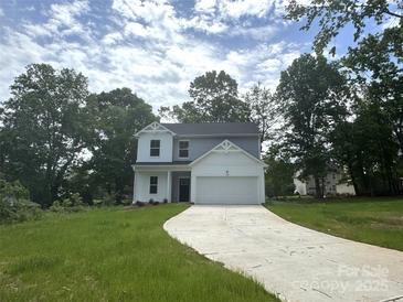 Charming two-story home with a well-manicured lawn and attached two-car garage at 168 Wildwood Loop, Statesville, NC 28625